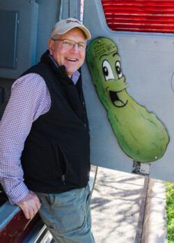 Dave Wright, Ocala, Fl. Dave and his wife Boots, purchased The Mighty Pickle in 2019, oversaw the masterful three year restoration and donated the freshly christened “The Chief” to Marty Stuart’s Congress of Country Music Museum in Philadelphia, Mississippi. Dave is pictured with the wooden pickle that was part of The Mighty Pickle interior decoration, now mounted behind the baggage door of The Chief. Ocala, FL (2023) Dave and the Pickle