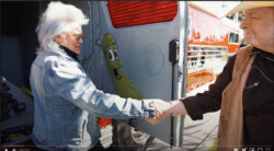Marty Stuart & Rambler Rick shake hands after Rick
autographs the wooden pickle mounted on the inside of the baggage door of “The Chief,” Ocala, FL (2023)