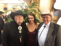 Rambler Rick, Taryn, and Alan Reynolds, host of “Pure Country” on WIOX 91.3 FM Radio in Roxbury, NY at the Academy of Western Artists awards ceremony, Fort Worth, TX (2019)