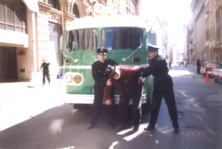 Rick is wrestled down by 1960s faux police officers on the set of the Jennifer Love Hewitt biopic “The Audrey Hepburn Story” Montreal, Canada (2000)