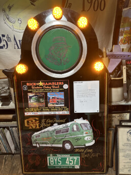 Closeup of the Pickle Commemorative piece built by the Mighty Pickle restoration team featuring an etching of Rick, running lights, poster and letter from Marty Stuart and the last Vermont license plate off the Mighty Pickle.